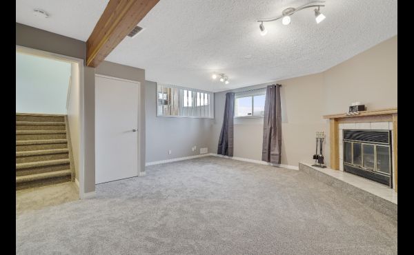 Generous family room with fireplace on third level